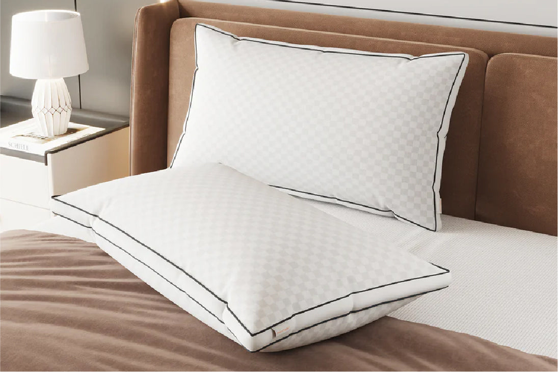 Comfort Support Pillow 2-Pack: White quilted pillows with black piping for a luxury sleep experience.